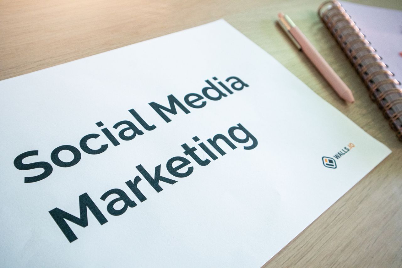 heros-img Close-up of a social media marketing document on a desk with a pen and notebook.